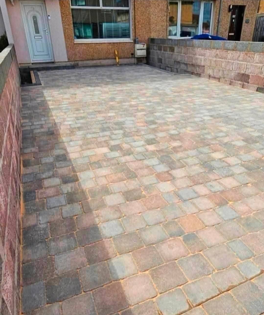 Finished multi-tone block-paved driveway at the front of a house, by Paradigm Paving & Driveways