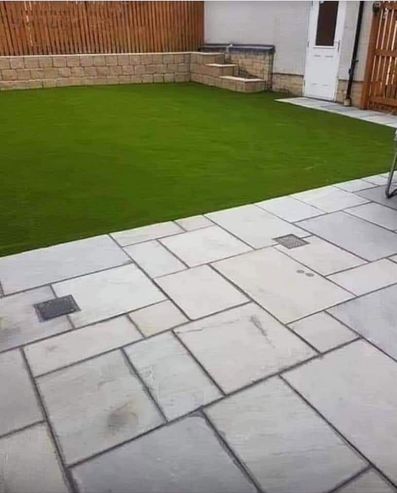 Artificial lawn beside a stone-effect patio