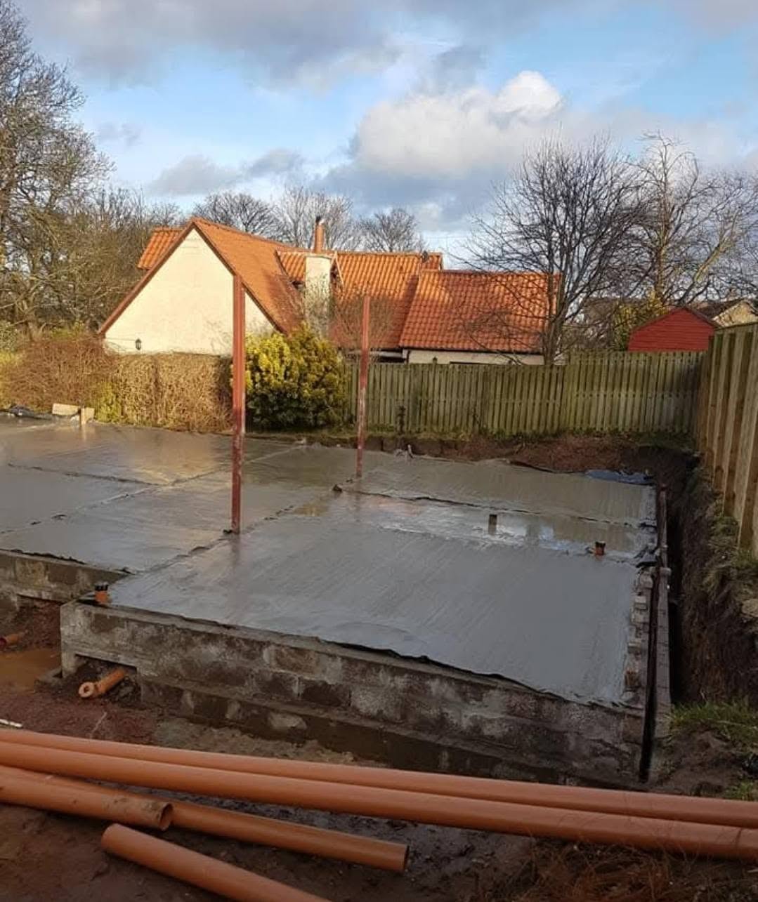 Concrete base with drainage pipework during groundworks